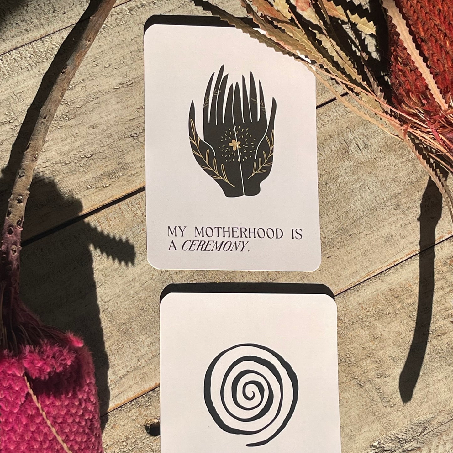 New Mama Deck cover featuring 52 affirmation cards for postpartum mothers. two cards with symbolic designs - my motherhood is a ceremony